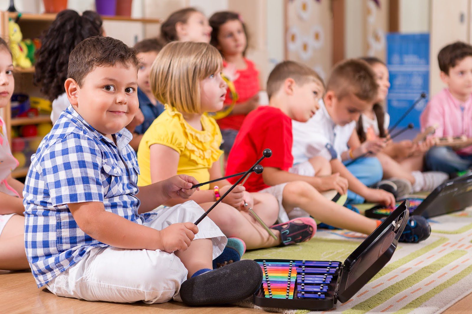 Preschool child in musical classroom.