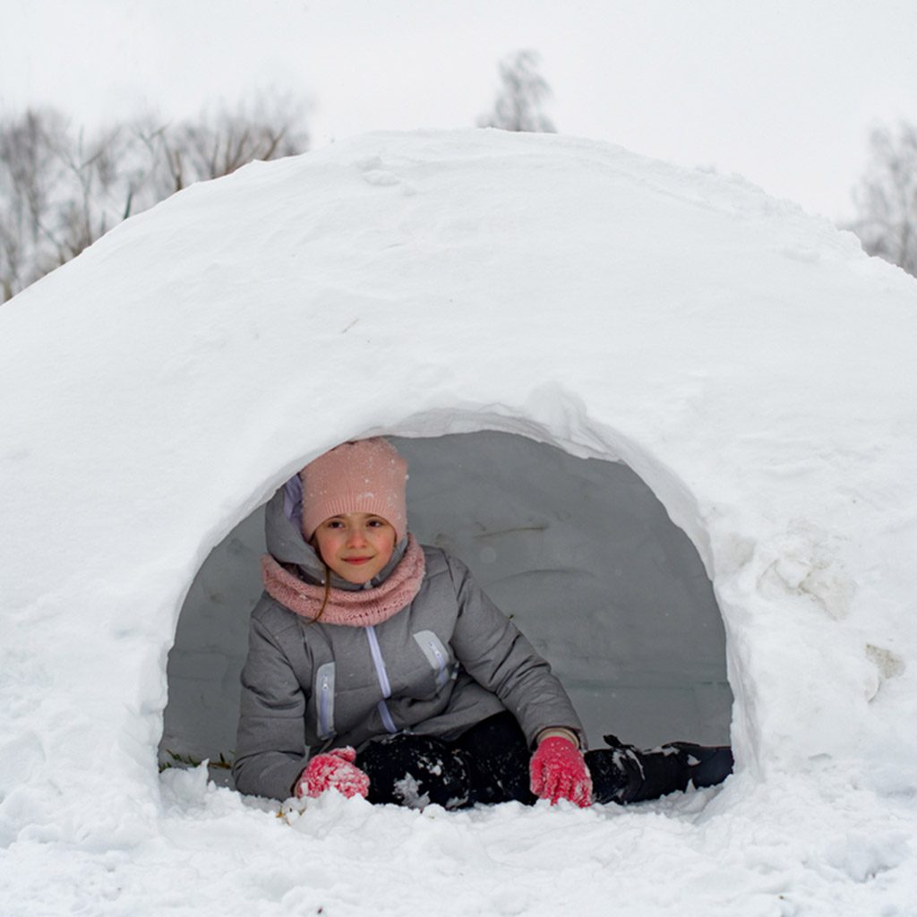 Girl,In,Winter,Clothes,Lying,On,The,Snow,Near,The